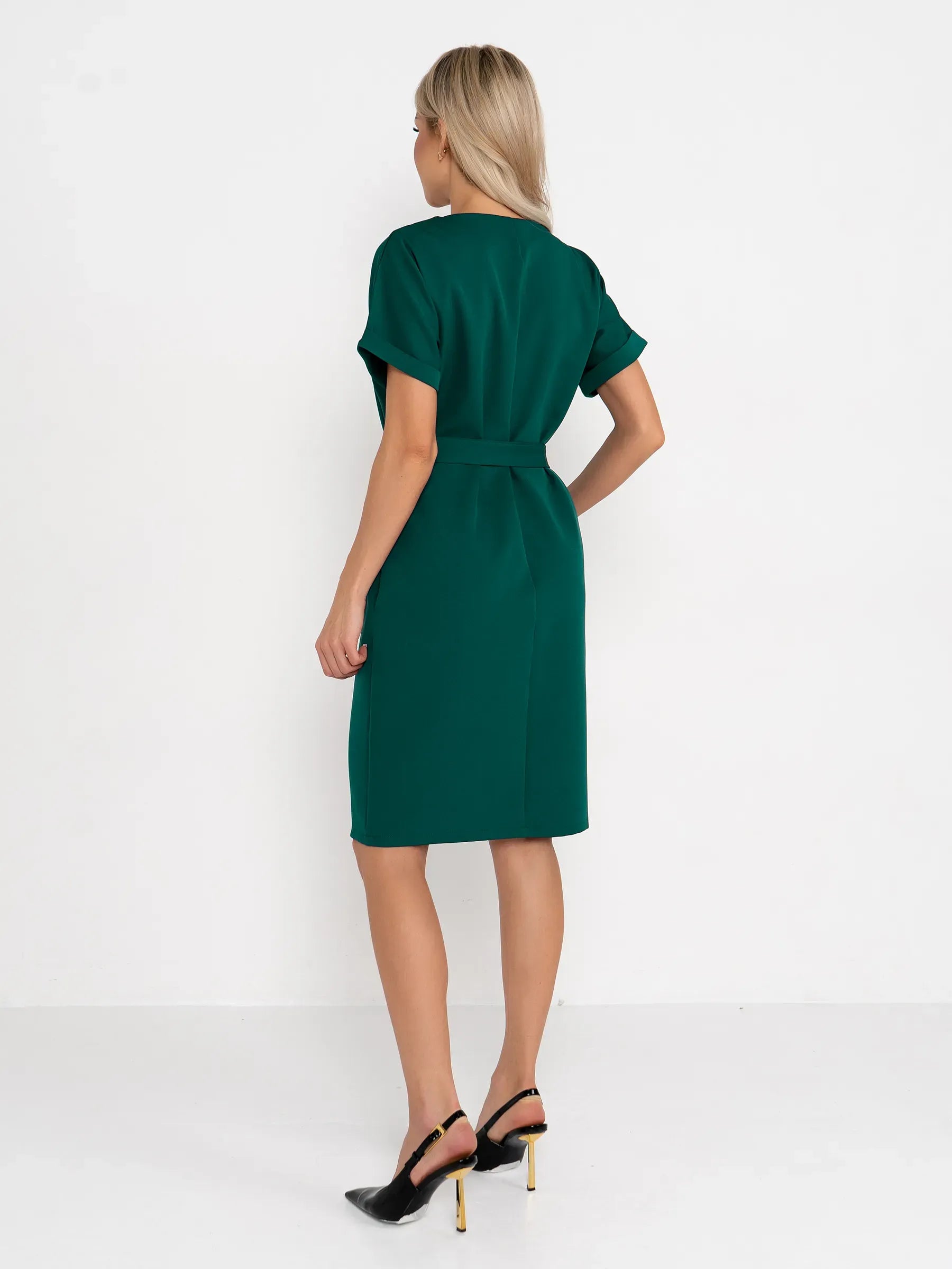 Back view of Emerald Mode green mini dress with cuffed sleeves and fabric belt, perfect for weddings and events.