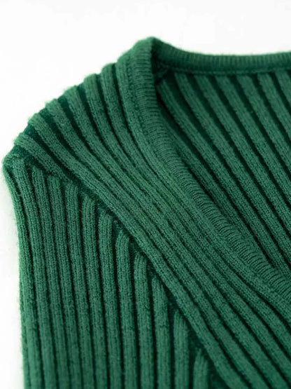 Close-up detail of the ribbed knit texture on the Sculpted Knit Midi Dress in forest green.