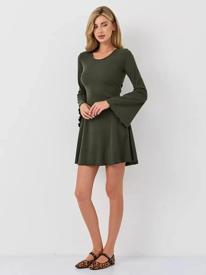 Model wearing Ivy Bell mini dress in olive green with flared bell sleeves, perfect for summer and casual occasions.