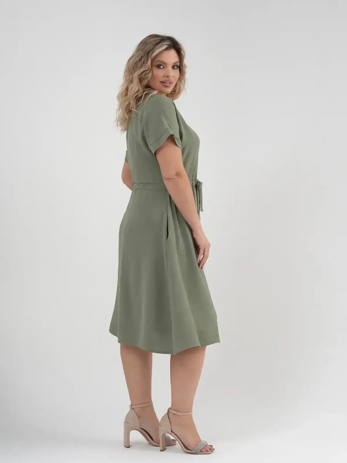 Back view of a woman in a khaki Botany Midi Dress showcasing its breathable design, perfect for summer occasions.