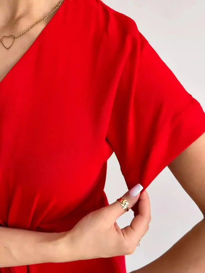 Close-up of Crimson Charm Midi Dress featuring a vibrant red fabric and elegant short sleeves.