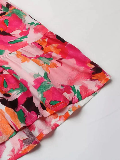 Close-up of vibrant Sunset Stripe Midi Dress featuring a colorful floral print in pink and orange hues.