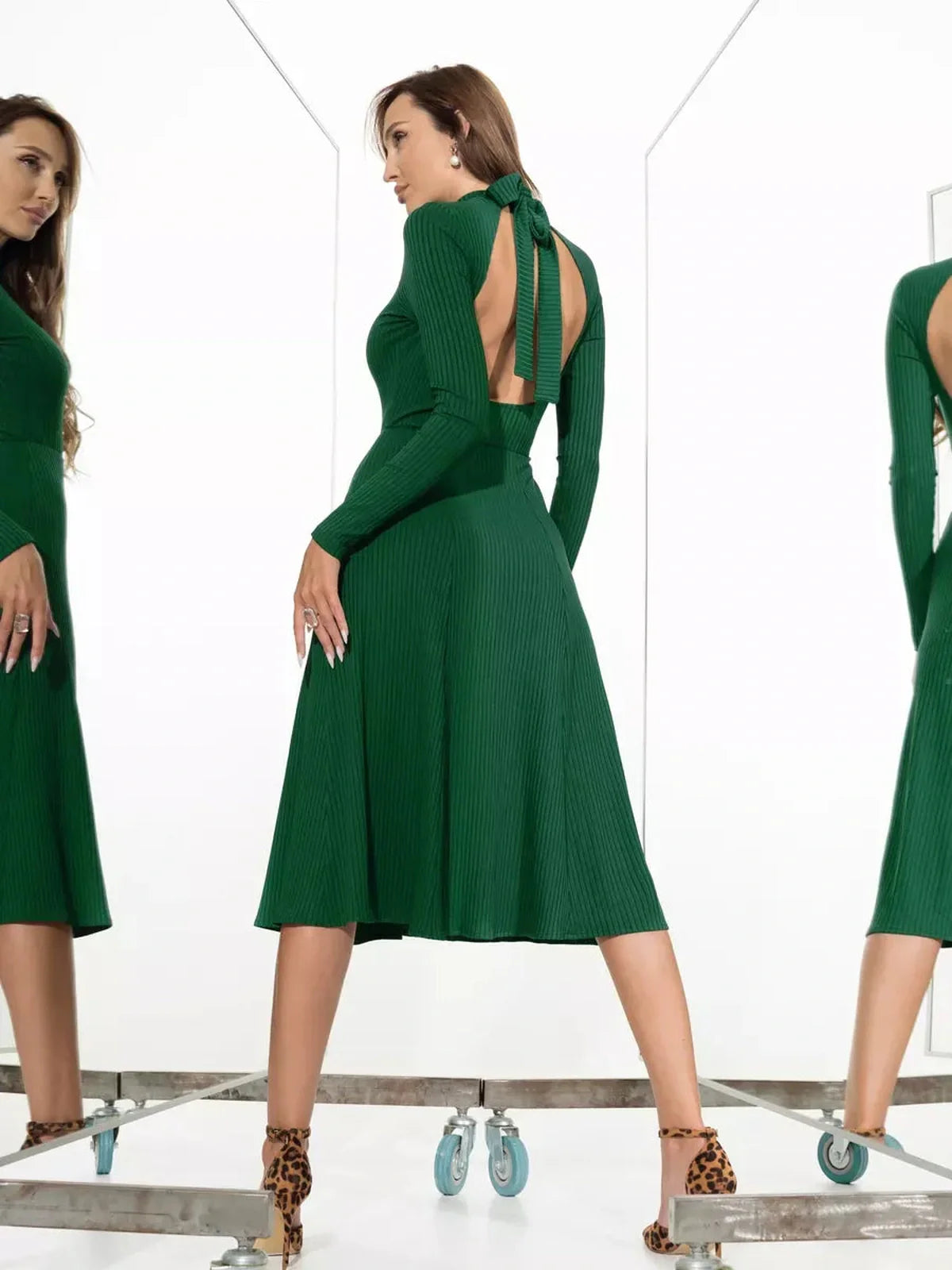 Emerald Grace Midi Dress showcasing backless design and dramatic bow detail, perfect for weddings and formal occasions.