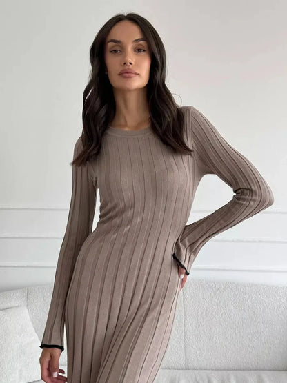 Model wearing a Contour Maxi Dress in ribbed knit, showcasing a full-length silhouette and elegant long sleeves.