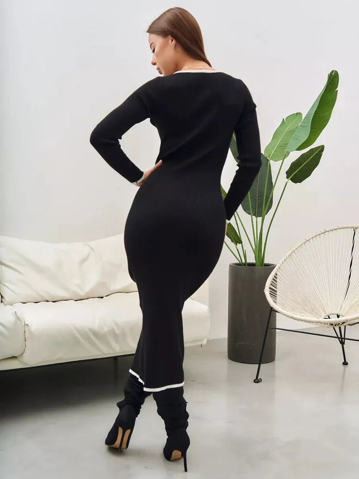 Elegant black midi dress with contrast trim, showcasing a chic silhouette and perfect for formal occasions.