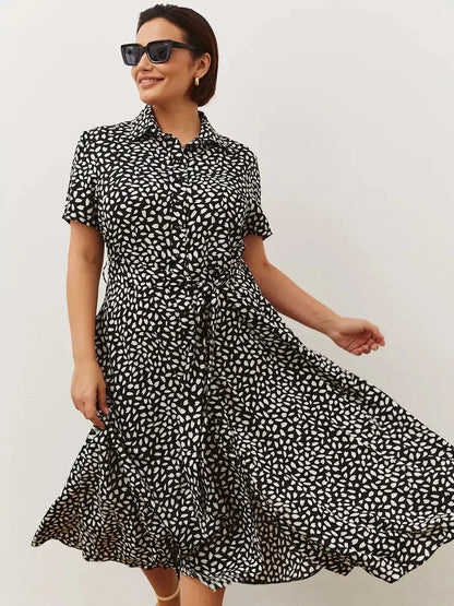Monaco Midi Dress in black and white print, featuring a shirt-dress silhouette, perfect for weddings and everyday elegance.