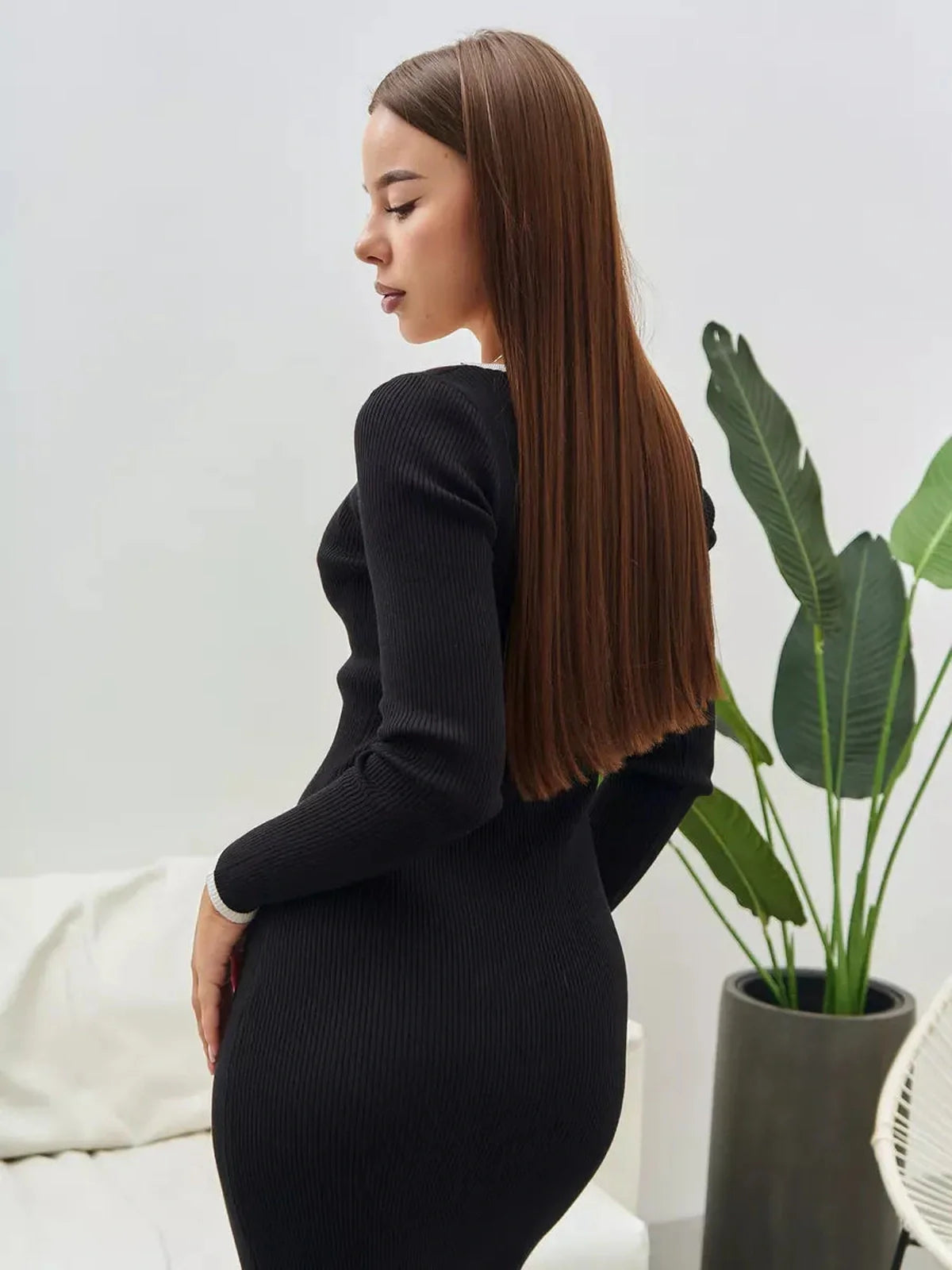 Model showcasing a sleek black Contrast Button Midi Dress, perfect for weddings and formal occasions.