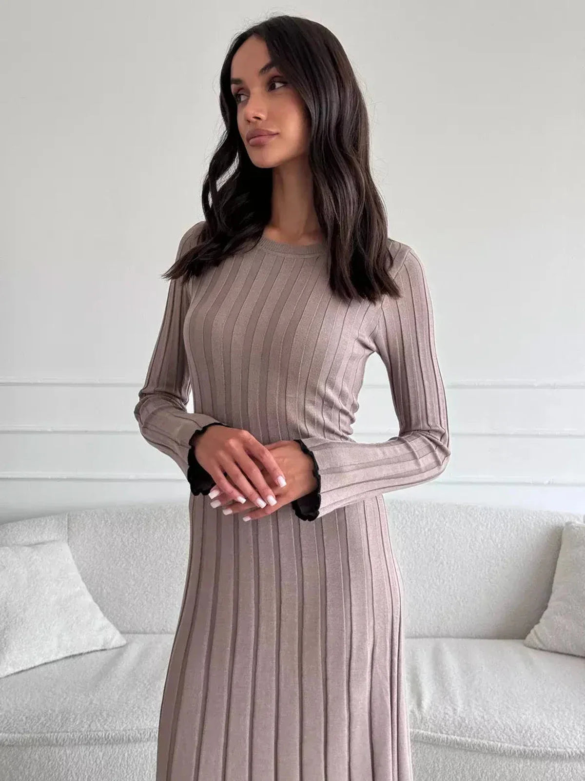 Contemporary ribbed knit Contour Maxi Dress with long sleeves and ruffle hem, perfect for weddings and formal events.