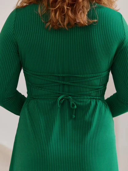 Back view of the Luxe Sculpt Midi Dress showcasing elegant waist tie detailing and ribbed texture in vibrant green.