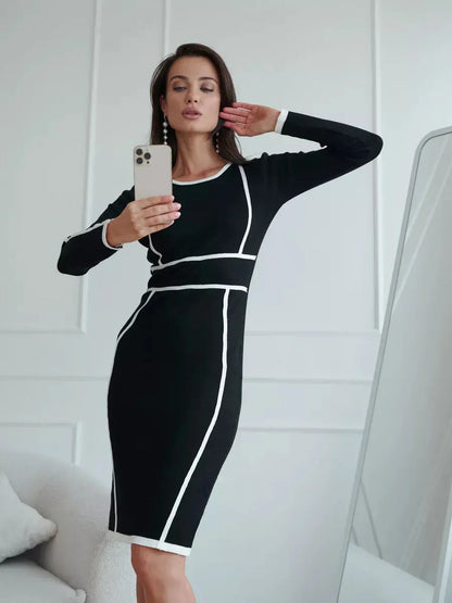 Elegant black midi dress with white contrast trimming, perfect for cocktail events and special occasions.