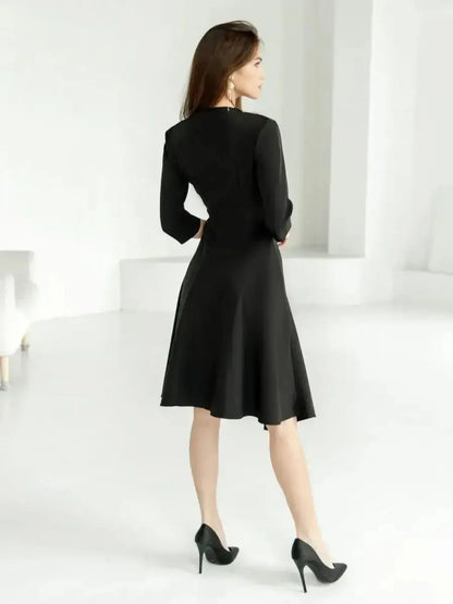 Sleek woman in a black midi dress with a flowing hem, showcasing elegance and modern sophistication, perfect for special occasions.