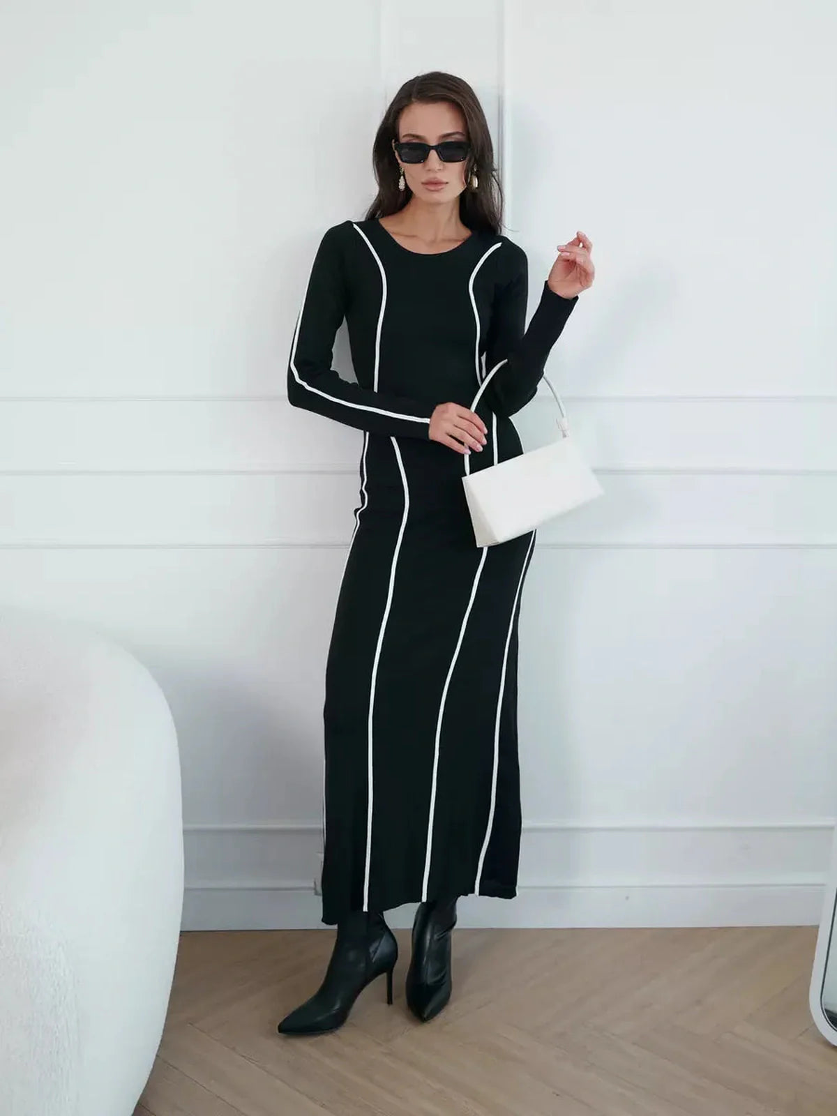 Elegant black maxi dress with contrast white piping, perfect for weddings, cocktail events, and formal occasions.