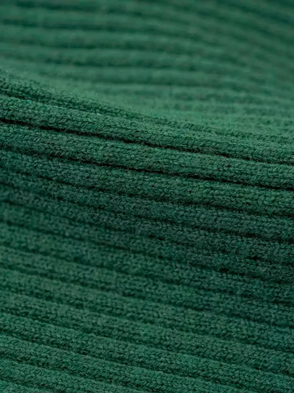 Close-up of textured forest green ribbed knit fabric for the Sculpted Knit Midi Dress.