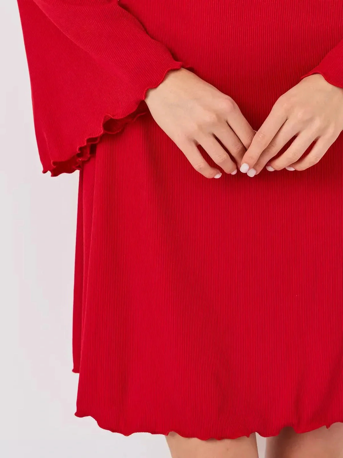 Close-up of a red flare cutout mini dress showcasing textured fabric and stylish ruffled hem details.