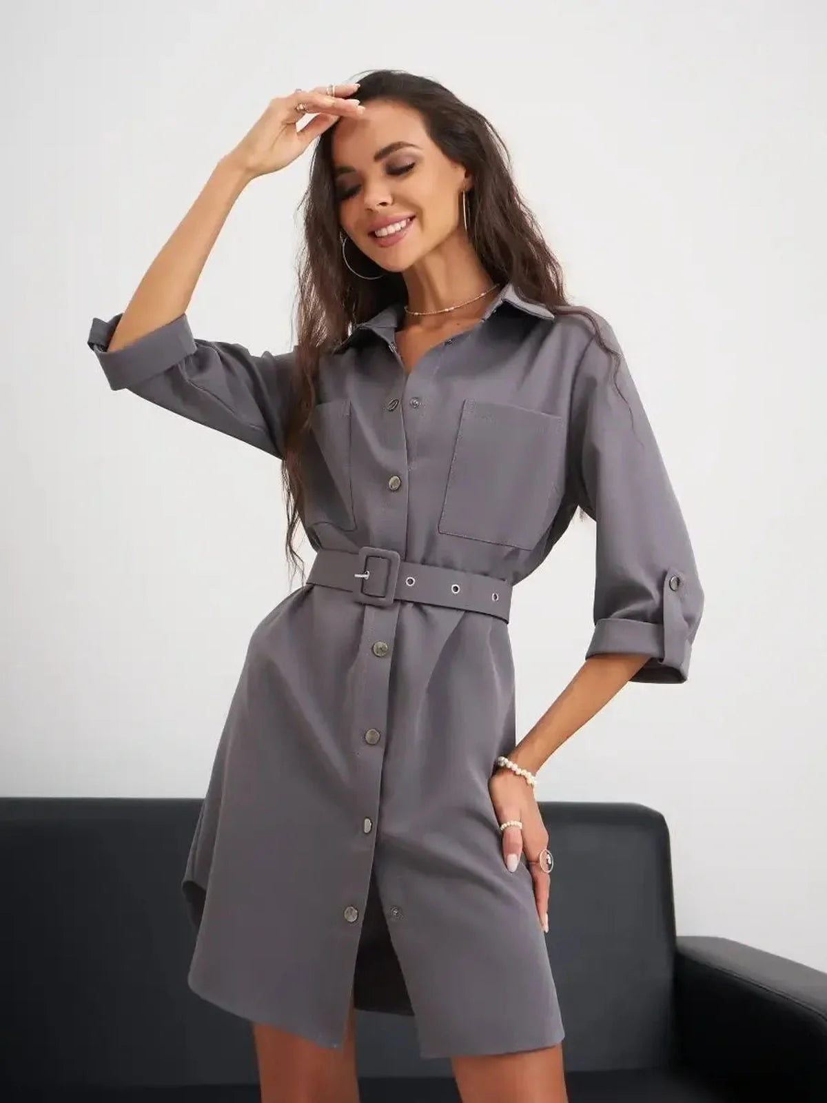 Stylish woman in a gray mini dress with a belt, perfect for summer outings and casual events.