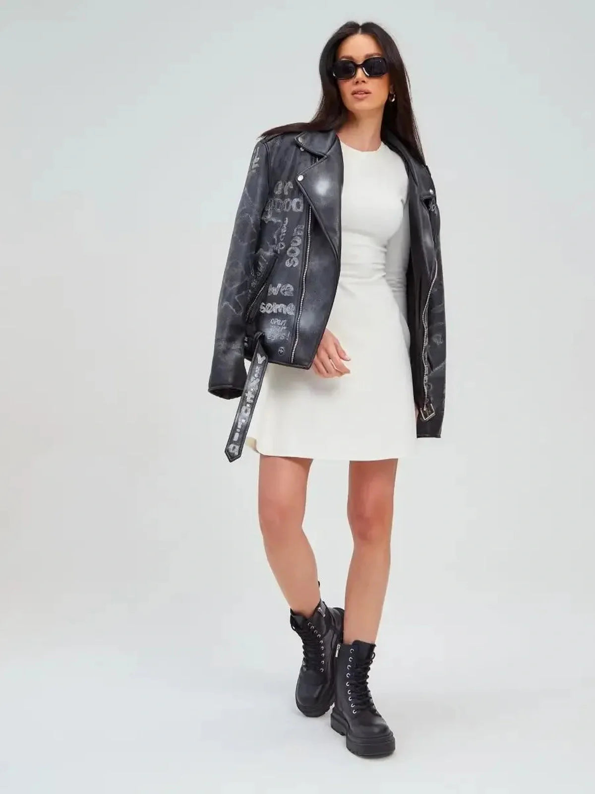 Model wearing the Ivory Sculpt Dress with a leather jacket and combat boots, showcasing a stylish, modern look.