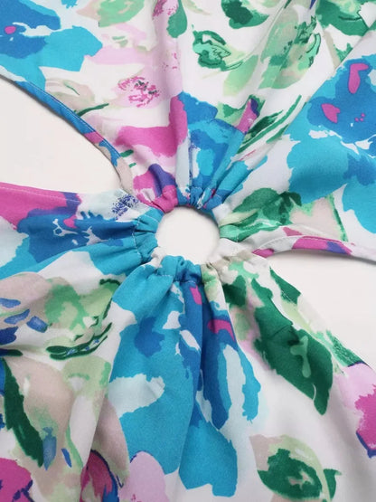 Close-up of colorful floral fabric for the Petal Bloom Midi Dress, showcasing vibrant pink, teal, and green hues.