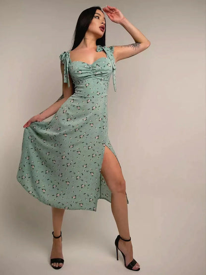 Flora Grace Midi Dress featuring romantic florals, statement bows, and side slit elegance perfect for weddings and events.