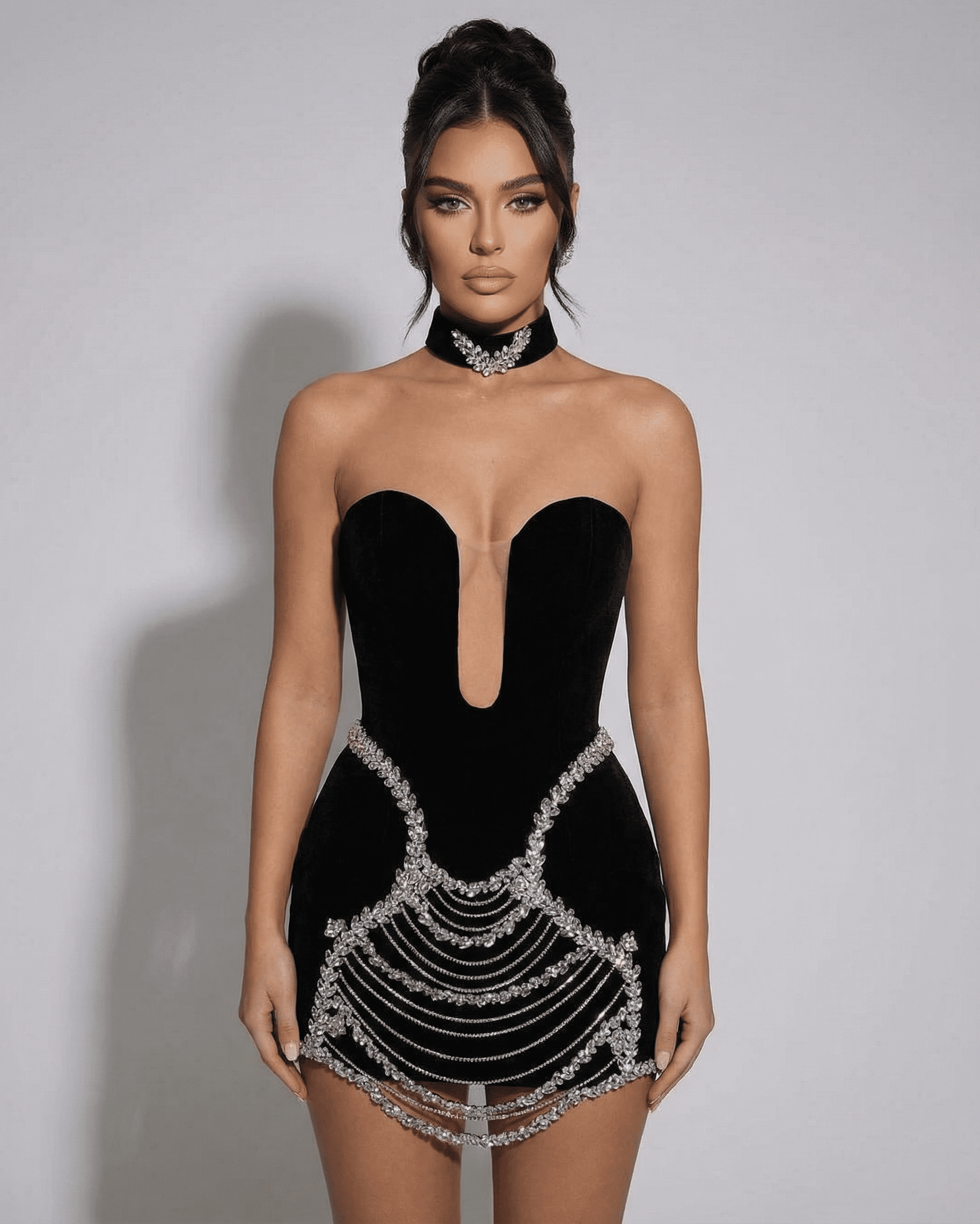 Celeste Mini Dress by Slimona features a black velvet bodycon design with rhinestone chain detailing.