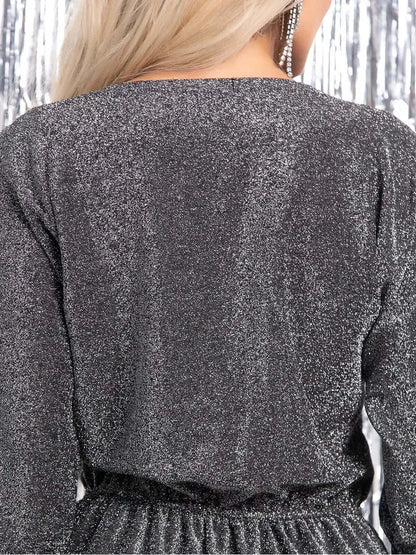 Back view of the Luna Shine Midi Dress showcasing its shimmering silver fabric and elegant design.