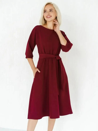 Elegant crimson midi dress with a self-tie belt, featuring a flowing silhouette perfect for formal or casual occasions.