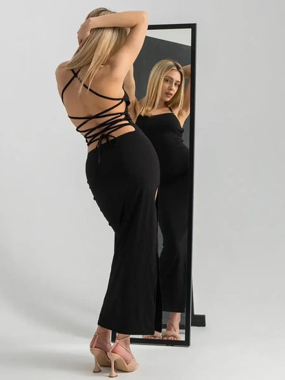 Noir Lace Midi Dress showcasing a sleek ribbed design with open lace-up back and thigh-high slit, perfect for evening elegance.