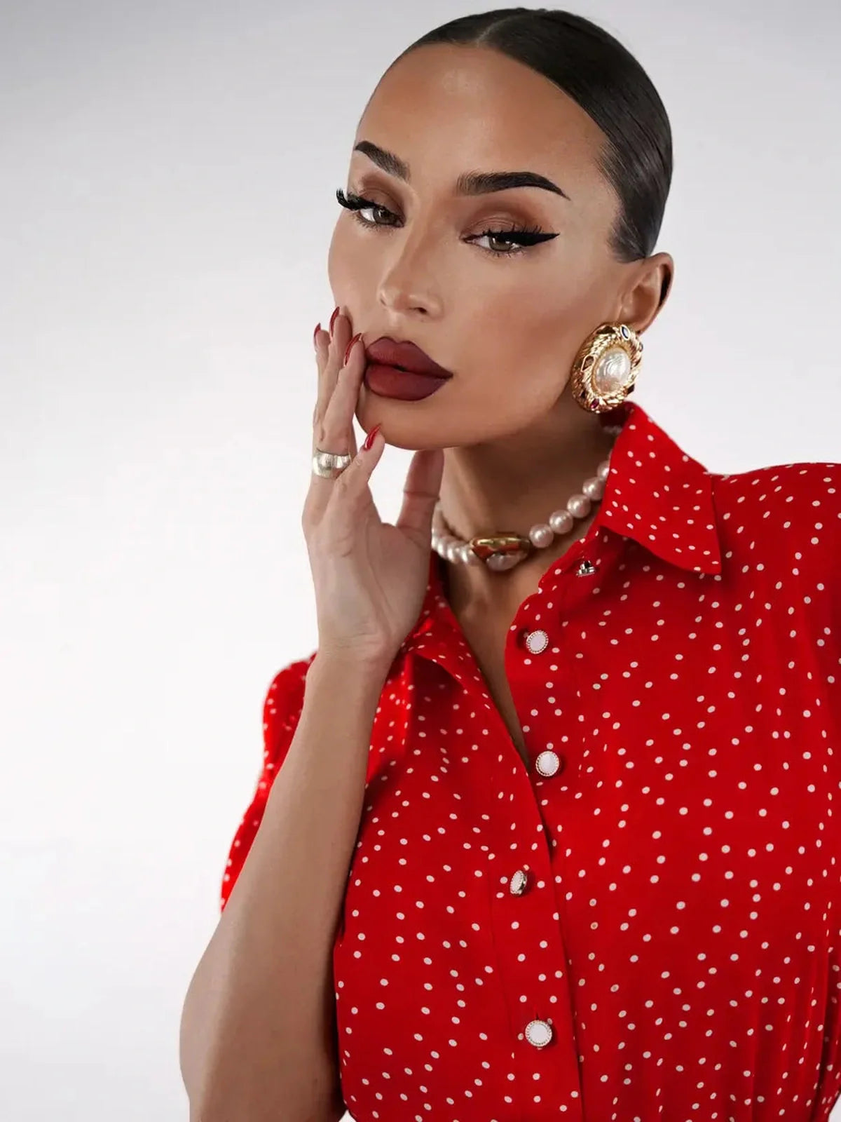 Model showcasing the Scarlet Dot Midi Dress with playful polka dots and elegant accessories, highlighting a chic fashion statement.