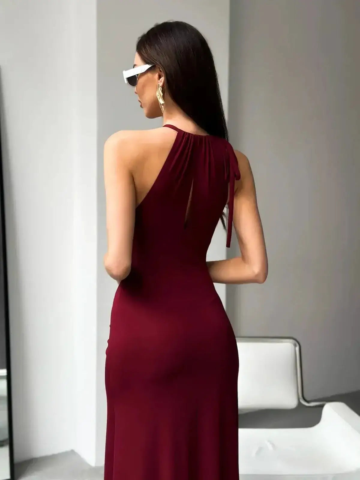 Back view of a burgundy halter maxi dress with a keyhole design, perfect for weddings and formal occasions.