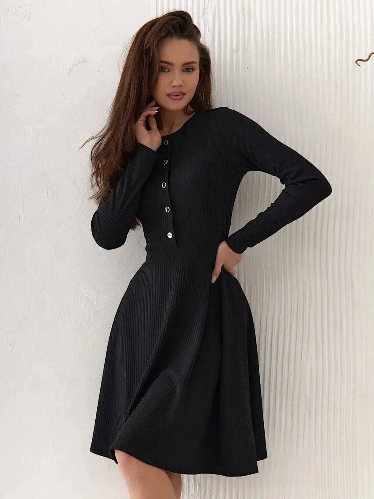 Elegant black Mod Noir dress with long sleeves, round neckline, and button details, perfect for formal and casual occasions.