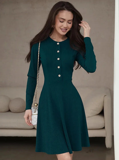Emerald mini dress with long sleeves, ribbed texture, and button placket, perfect for weddings or formal occasions.