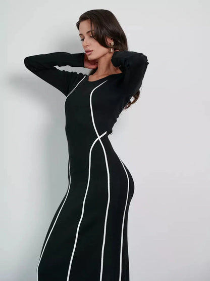Midnight Curve Maxi Dress featuring a sculpting silhouette with contrast piping. Elegant black dress for formal events and weddings.