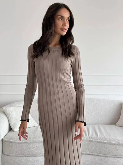 Model showcasing the Contour Maxi Dress in ribbed knit, highlighting its elegant silhouette and long sleeves.