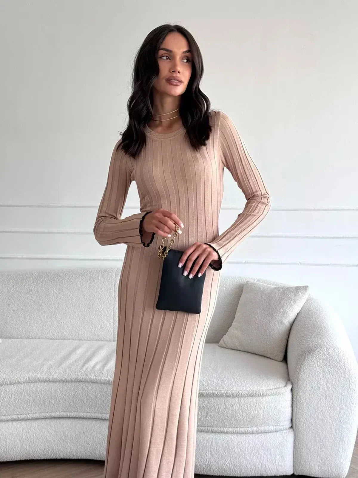 Model wearing the Sahara Curve Maxi Dress in Sandstone Beige, showcasing its elegant ribbed design and figure-hugging silhouette.