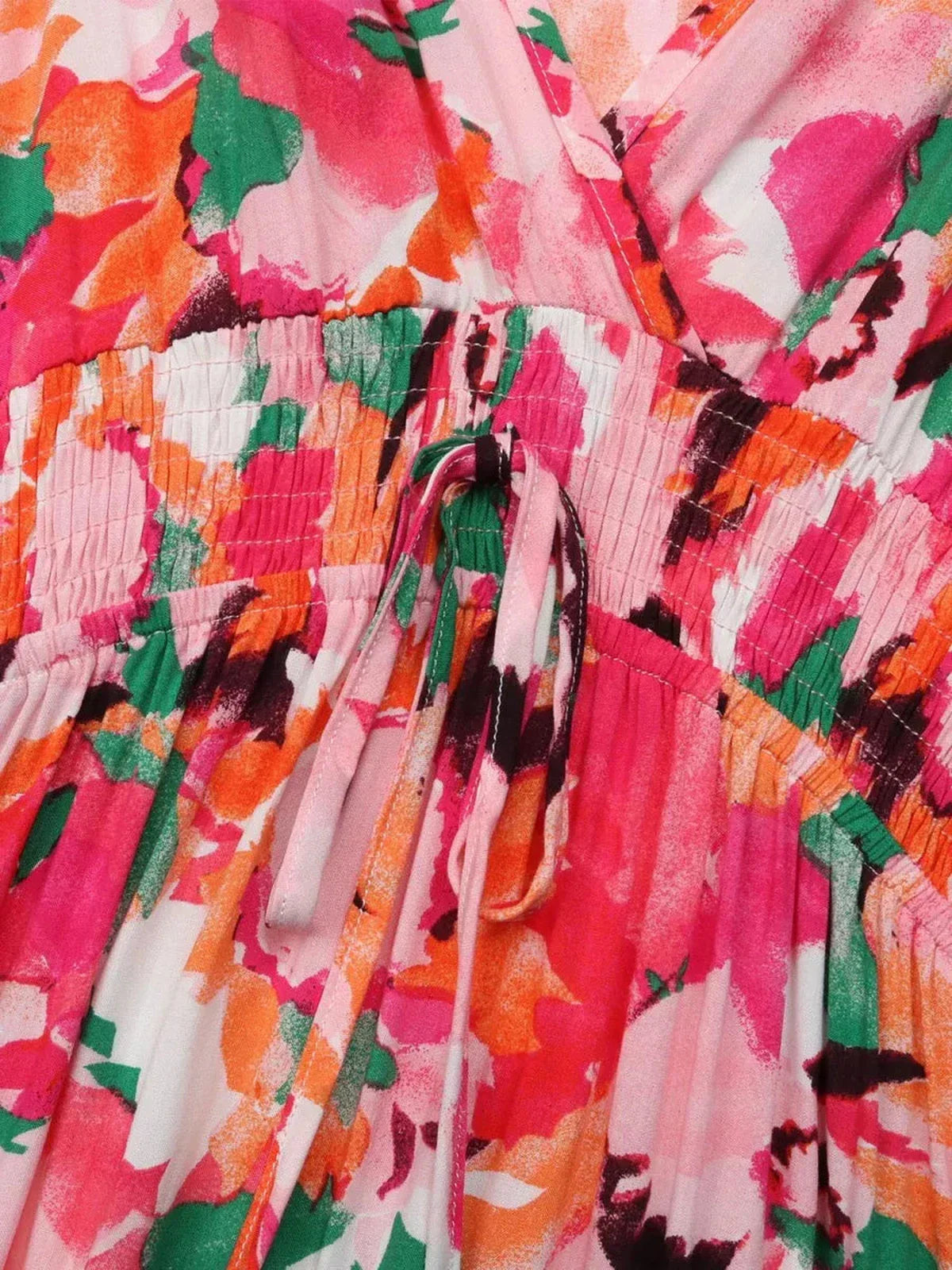 Close-up of the colorful floral print and tie-front detail on a Sunset Stripe Midi Dress.