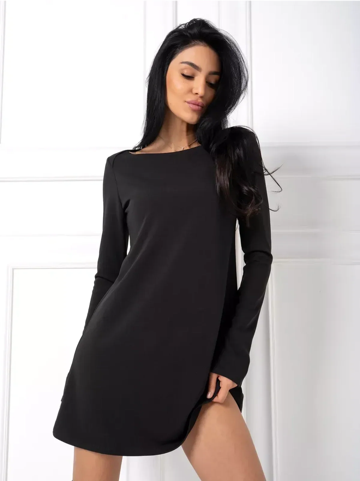 Midnight Flow black mini dress featuring a minimalist silhouette, flattering A-line cut, and long sleeves for a modern look.