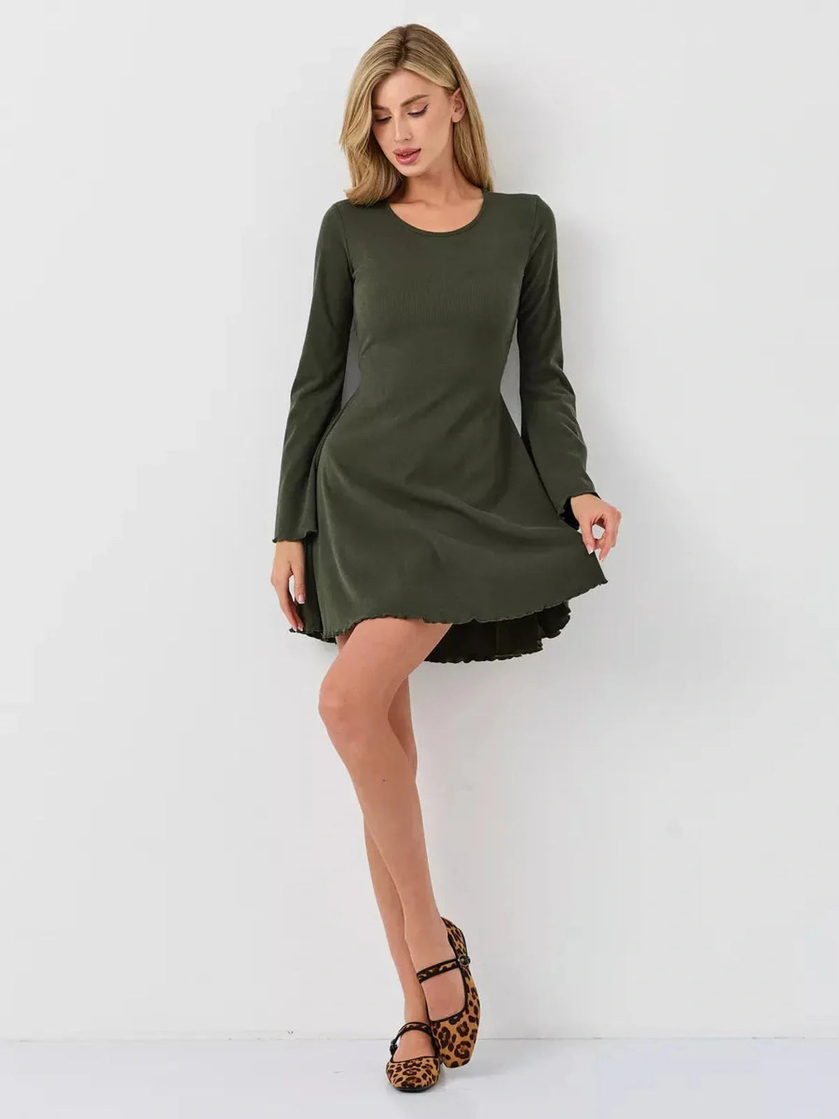 Model wearing a stylish olive green mini dress with long sleeves, perfect for casual or formal occasions.