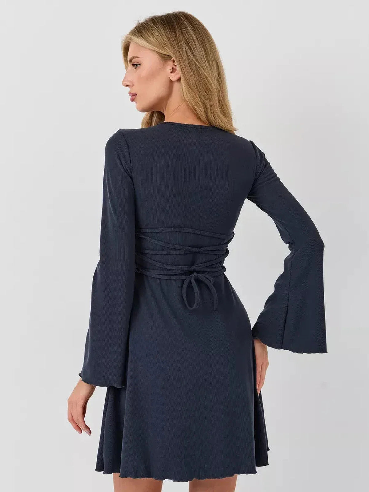 Back view of a stylish navy mini dress with bell sleeves and a tie waist, perfect for summer or cocktail events.