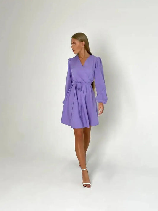Elegant feminine mini dress in lavender with V-neckline and cinched waist, perfect for summer and wedding guest occasions.