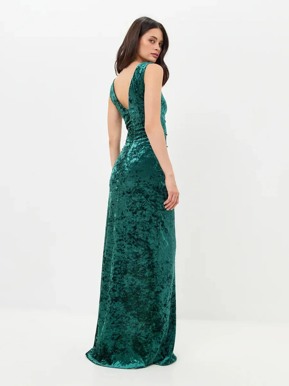 Elegant green Velvet Aura Maxi Dress with a back slit, showcasing a sleek fit and luxurious fabric for special occasions.