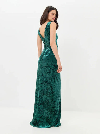 Elegant green Velvet Aura Maxi Dress with a back slit, showcasing a sleek fit and luxurious fabric for special occasions.