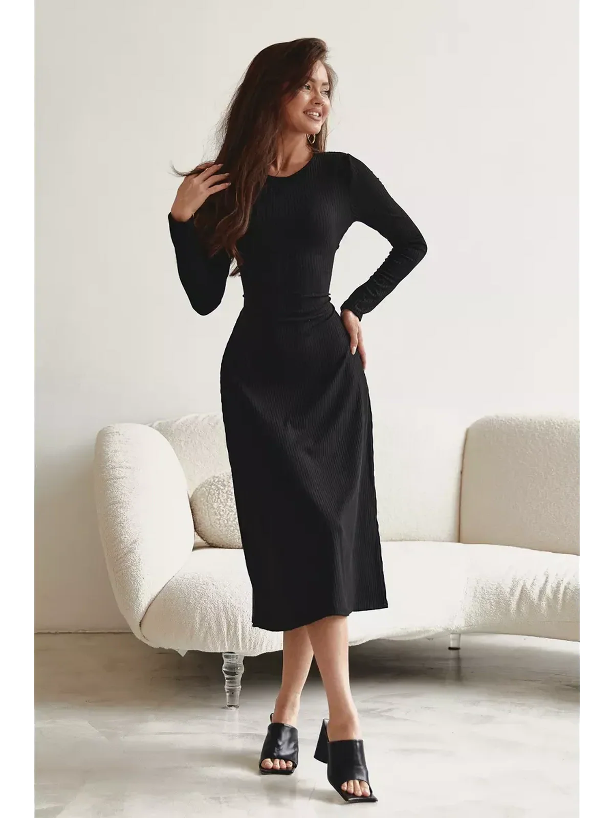Elegant black mid-length dress with long sleeves, perfect for formal occasions or casual outings.