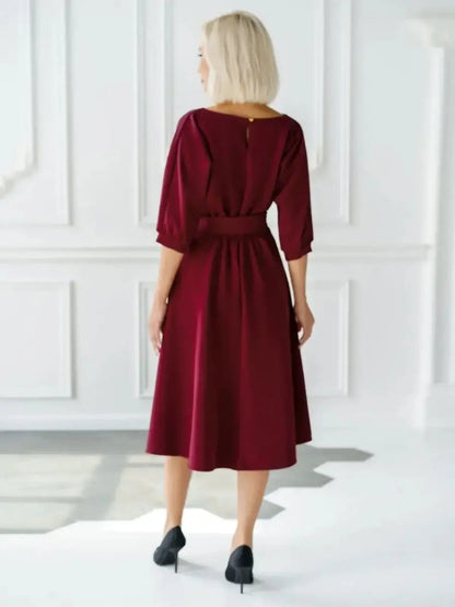 Back view of a woman in a burgundy midi dress with a self-tie belt, perfect for formal events and summer gatherings.