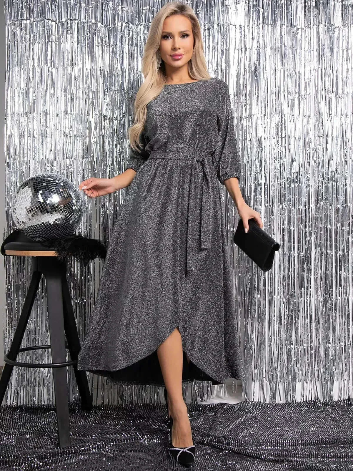 Elegant woman in shimmering Luna Shine Midi Dress with side slit, perfect for weddings, cocktail events, and evening glamour.