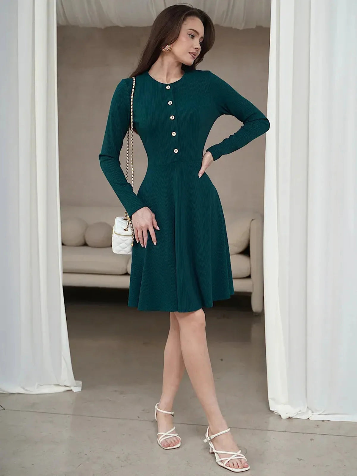 Emerald line mini dress with long sleeves, ribbed texture, and button placket, perfect for summer or formal occasions.