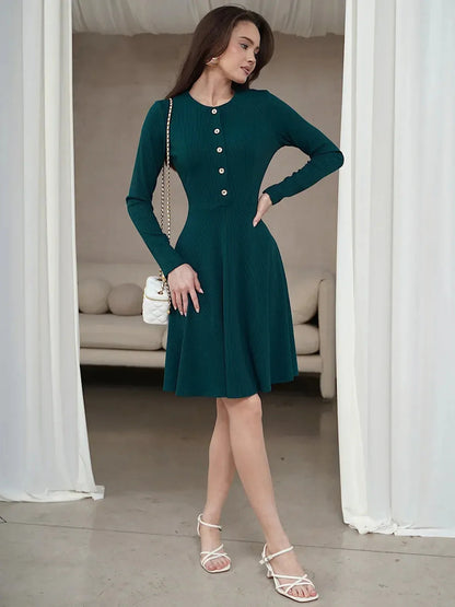 Emerald line mini dress with long sleeves, ribbed texture, and button placket, perfect for summer or formal occasions.