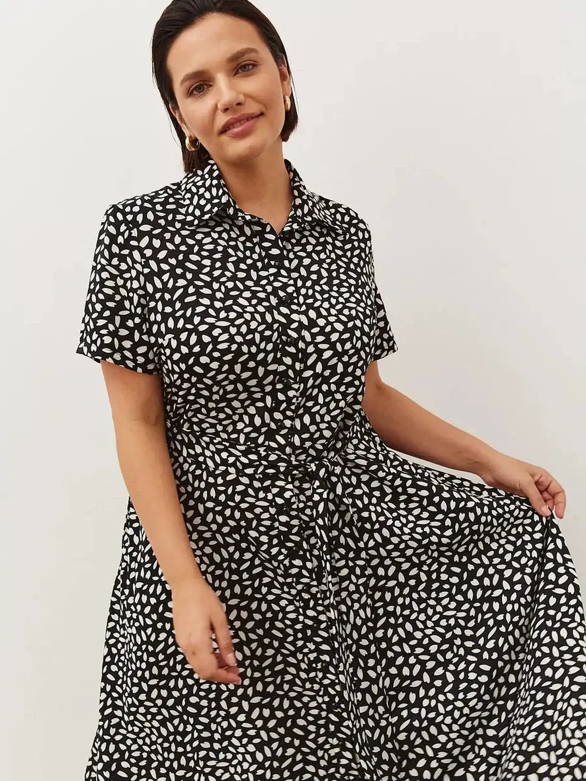 Monaco Midi Dress featuring a black and white print, epitomizing effortless sophistication and modern elegance.