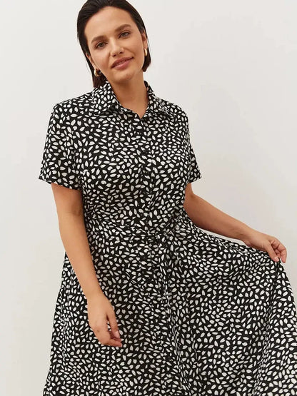 Monaco Midi Dress featuring a black and white print, epitomizing effortless sophistication and modern elegance.