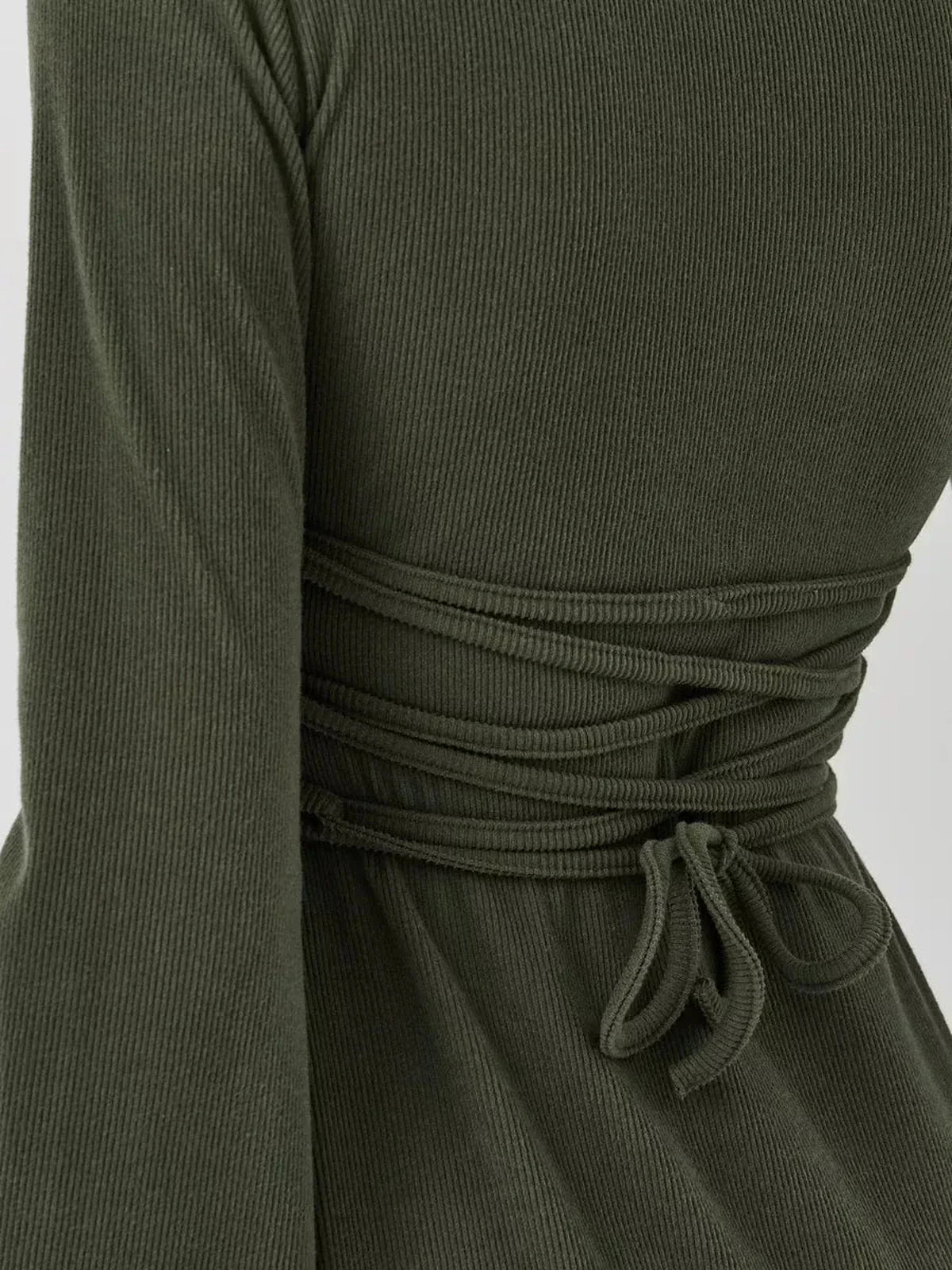 Back detail of Ivy Bell mini dress showing ribbed fabric and cinched waist for a flattering fit.