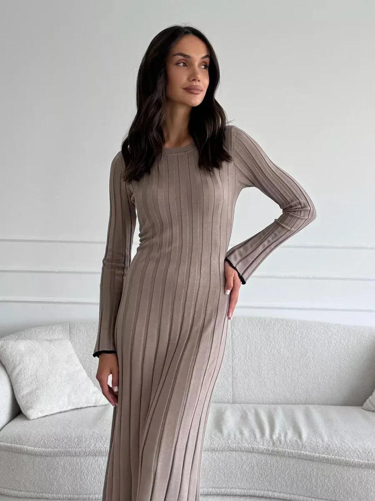 Model showcasing the Contour Maxi Dress in ribbed knit, highlighting its elegant silhouette and long sleeves.