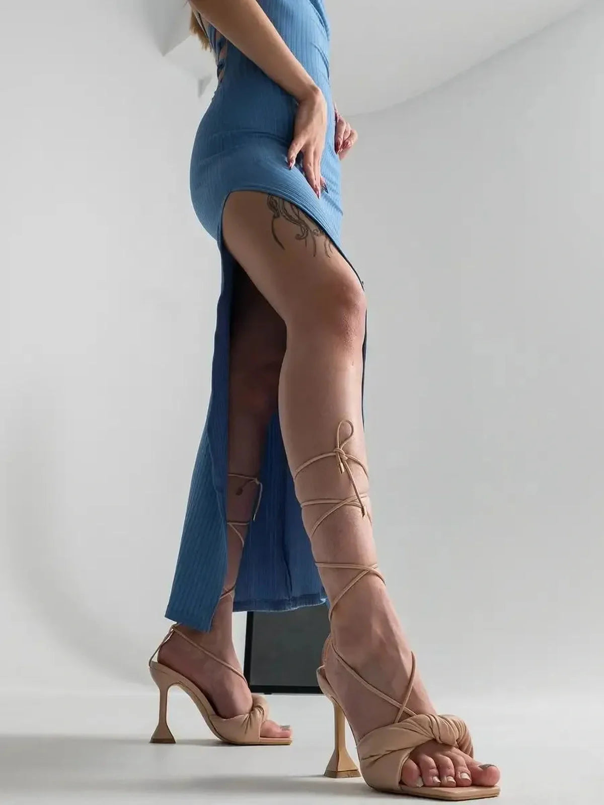 Ocean Lace Midi Dress featuring a daring side slit and elegant strappy heels, perfect for summer weddings and formal events.